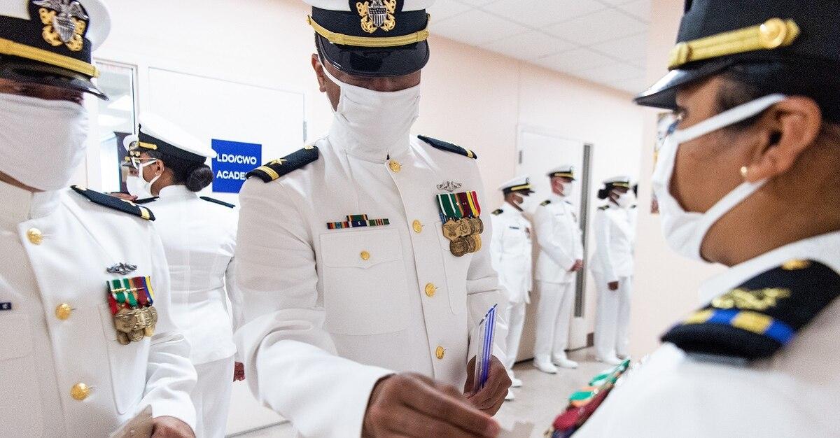 Limited Duty Officer/Chief Warrant Officer Academy students at Officer Training Command Newport, Rhode Island, learn to perform proper uniform inspections with their classmates. (Darwin Lam/Navy)