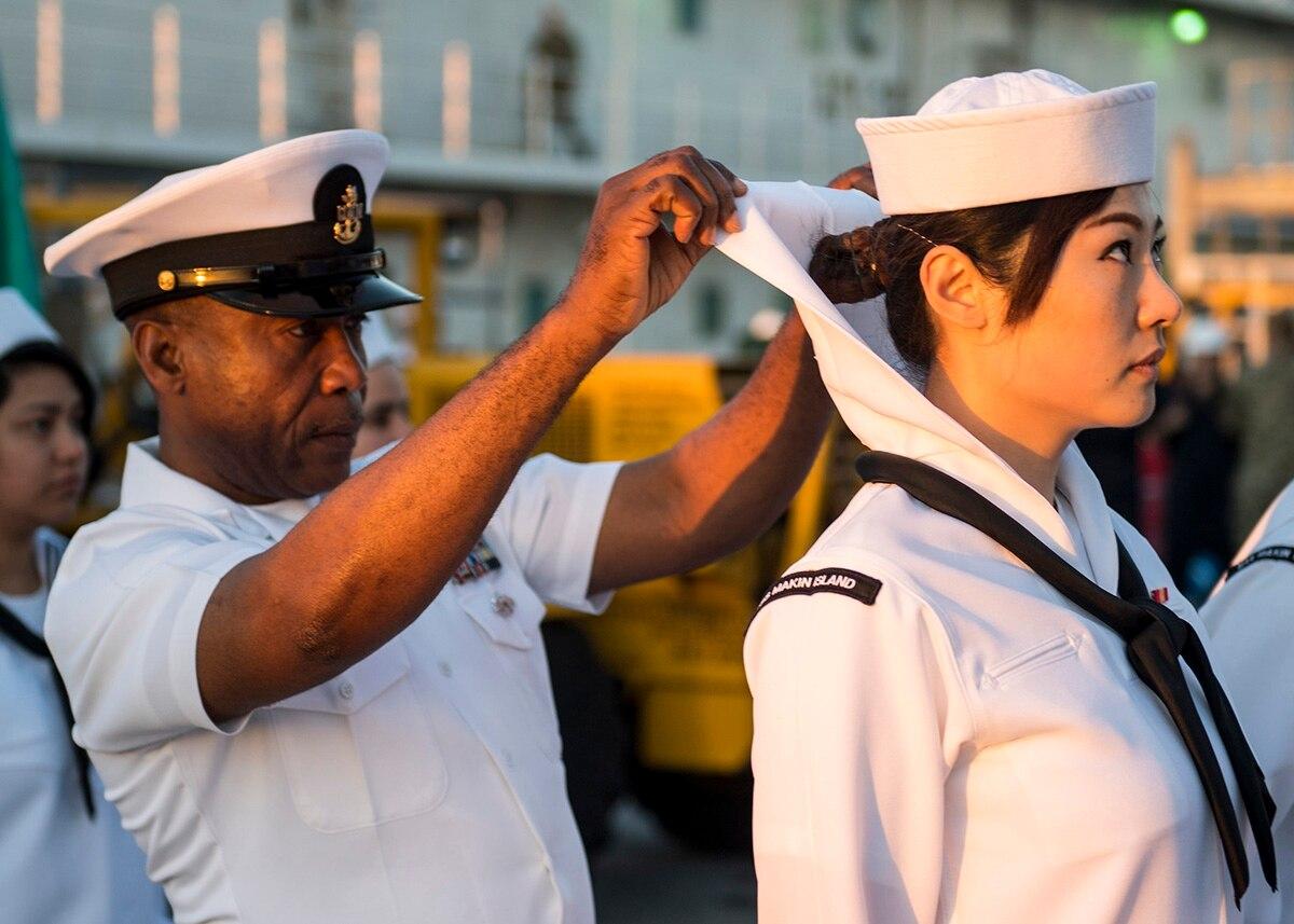 Senior Chief Aviation Support Equipment Technician Augustine Ilomuanya conducts a dress white uniform inspection in March 2019 aboard the amphibious assault ship Makin Island. (MC2 Colby Mothershead//Navy) Navy bans ‘faddish,’ ‘eccentric’ and other subjective terms from grooming regs