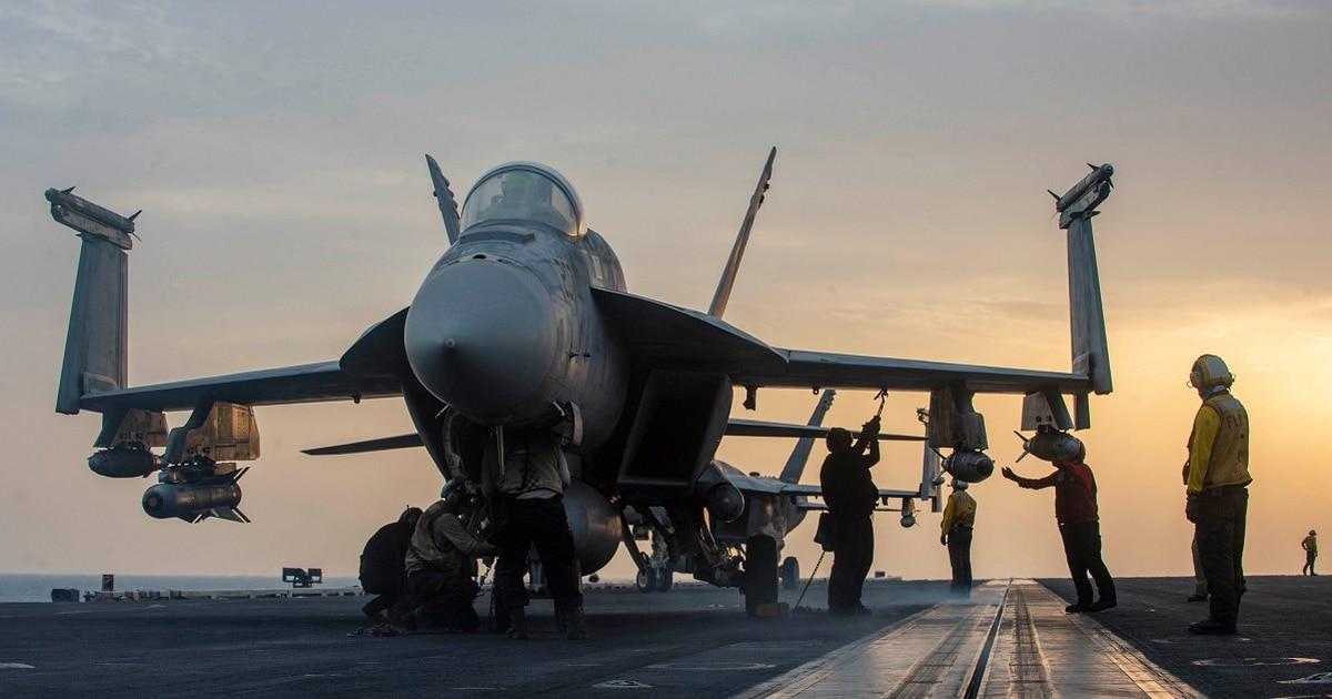 Sailors aboard the aircraft carrier Dwight D. Eisenhower secure an F/A-18E Super Hornet attached to the "Rampagers" of VFA-83 in early May. (Navy)