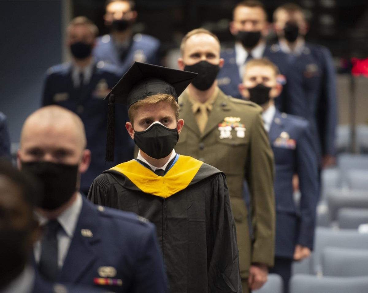 Nathan R. Boone and his classmates take their seats at the start of the Air Force Institute of Technology graduation ceremony March 25 at Wright-Patterson Air Force Base, Ohio. Approximately 250 advanced degrees were award Want to try that cool job or get more education? It wonâ€™t affect your promotion, Air Force says