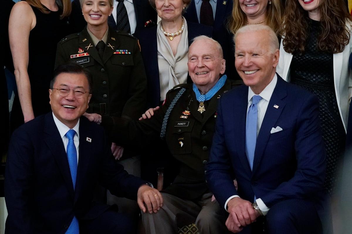 Bottom row, from left: South Korean President Moon Jae-in, retired U.S. Army Col. Ralph Puckett and President Joe Biden pose for a photo after Puckett was presented the Medal of Honor in the East Room of the White House, F