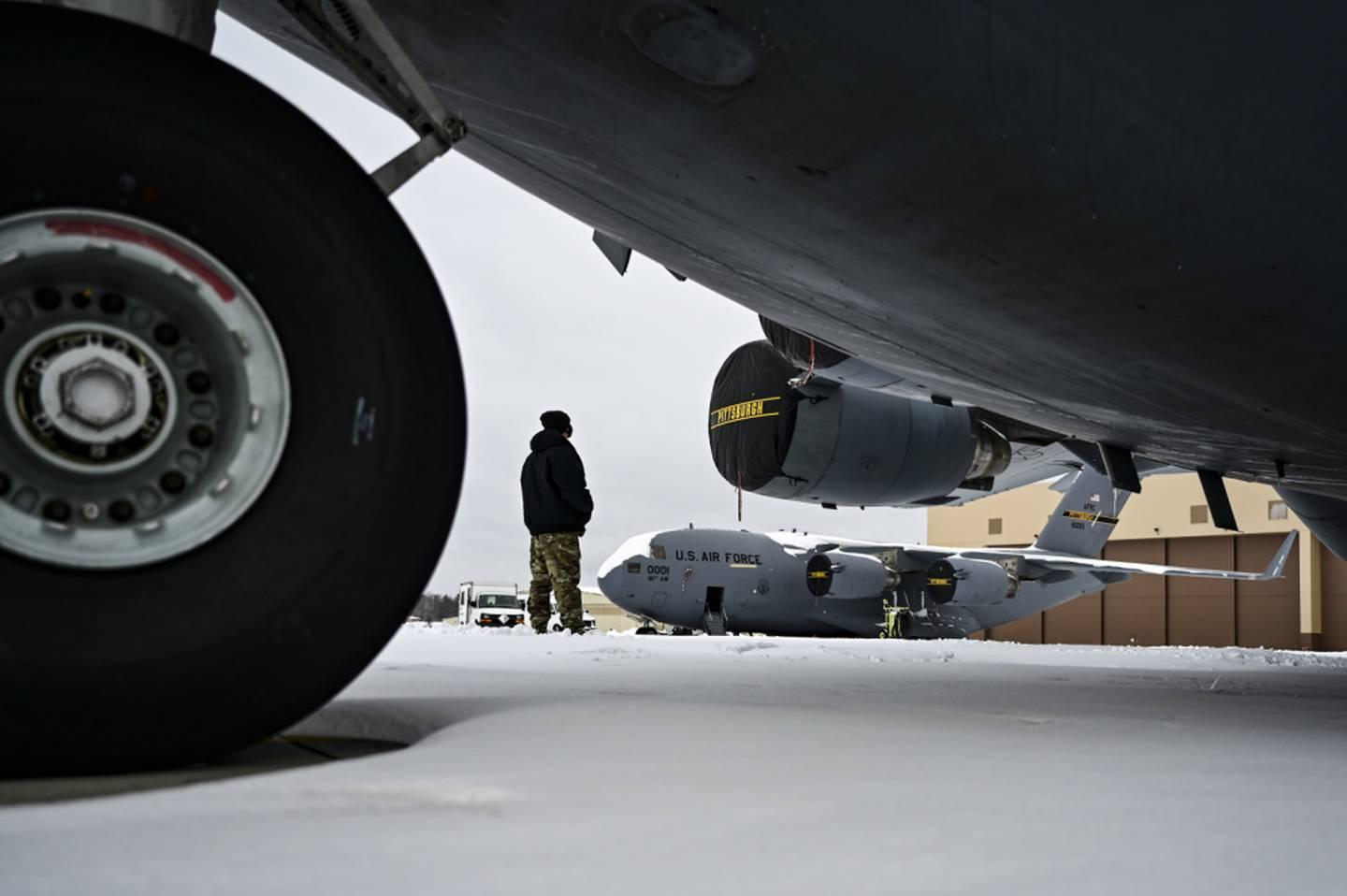 An Airman assigned to the 911th Aircraft Maintenance Squadron conducts a walk-around inspection on a C-17 Globemaster III at the Pittsburgh International Airport Air Reserve Station, Pennsylvania, on Feb. 1, 2021. (Joshua  Hair, hands and hosiery: Air Force overhauling outdated rules on airmen’s looks
