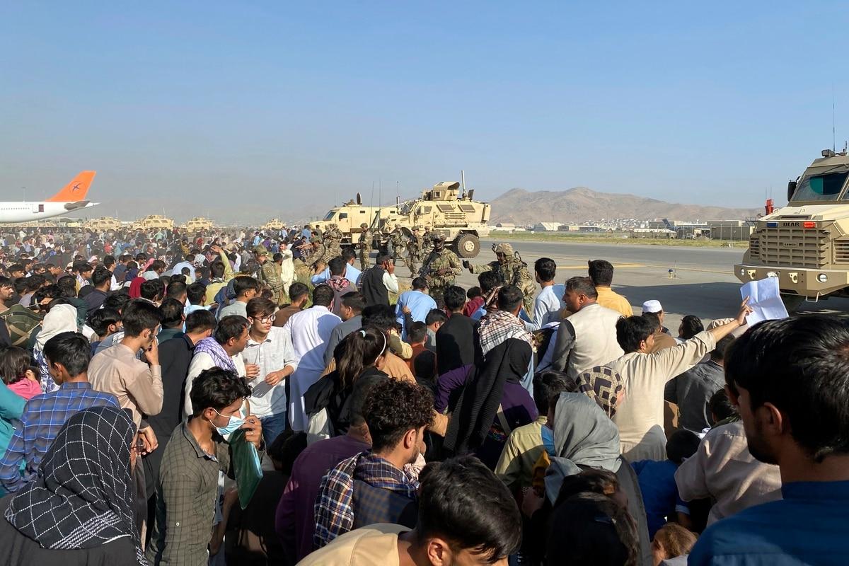 U.S soldiers stand guard along a perimeter at the international airport in Kabul, Afghanistan, Monday, Aug. 16, 2021. (AP Photo/Shekib Rahmani) â€˜Team Americaâ€™ has success evacuating Afghans, seeks help as requests grow