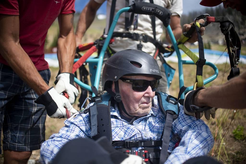 Fred Miles is strapped into an adaptive paragliding chair before his adaptive paragliding flight at Jackson Hole Mountain Resort on Wednesday, July 28, 2021 in Teton Village, Wyo.. At 103 years old, Miles set a record for 