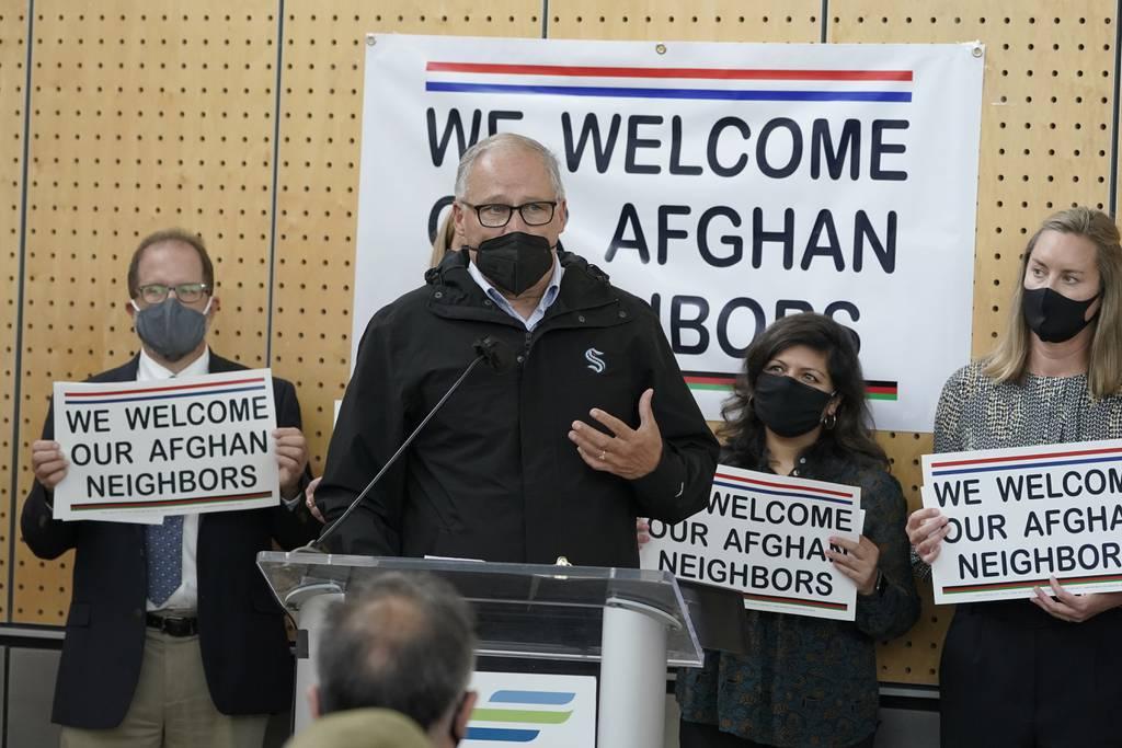 FILE - Washington Gov. Jay Inslee speaks during a news conference at the Afghan Welcome Center at the Seattle-Tacoma International Airport in Seattle, in this Friday, Oct. 22, 2021, file photo. Ordinary Americans and the n Miles donations are providing flights for Afghan refugees