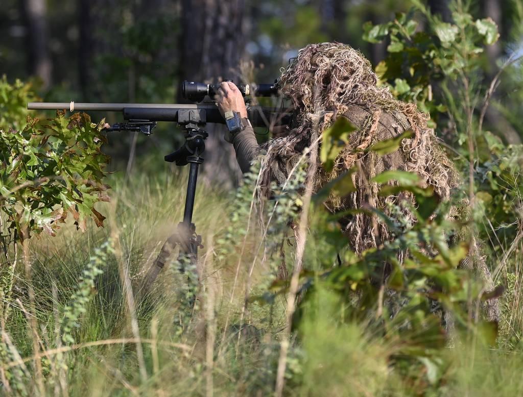A student assigned to the U.S. Army John F. Kennedy Special Warfare Center and School who is in the Special Forces Sniper Course adjusts a scope during sniper training at Fort Bragg, North Carolina, August 2, 2021. (Army/K First woman to finish Armyâ€™s sniper school is Montana Guard soldier