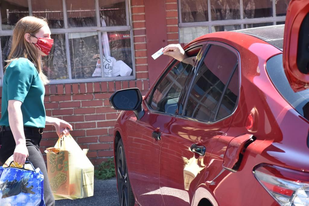 A staff member at the Fort Bragg, N.C., branch of the Armed Services YMCA takes bags of food to a military family's car. (Armed Services YMCA) Military food insecurity is getting a Pentagon-level review