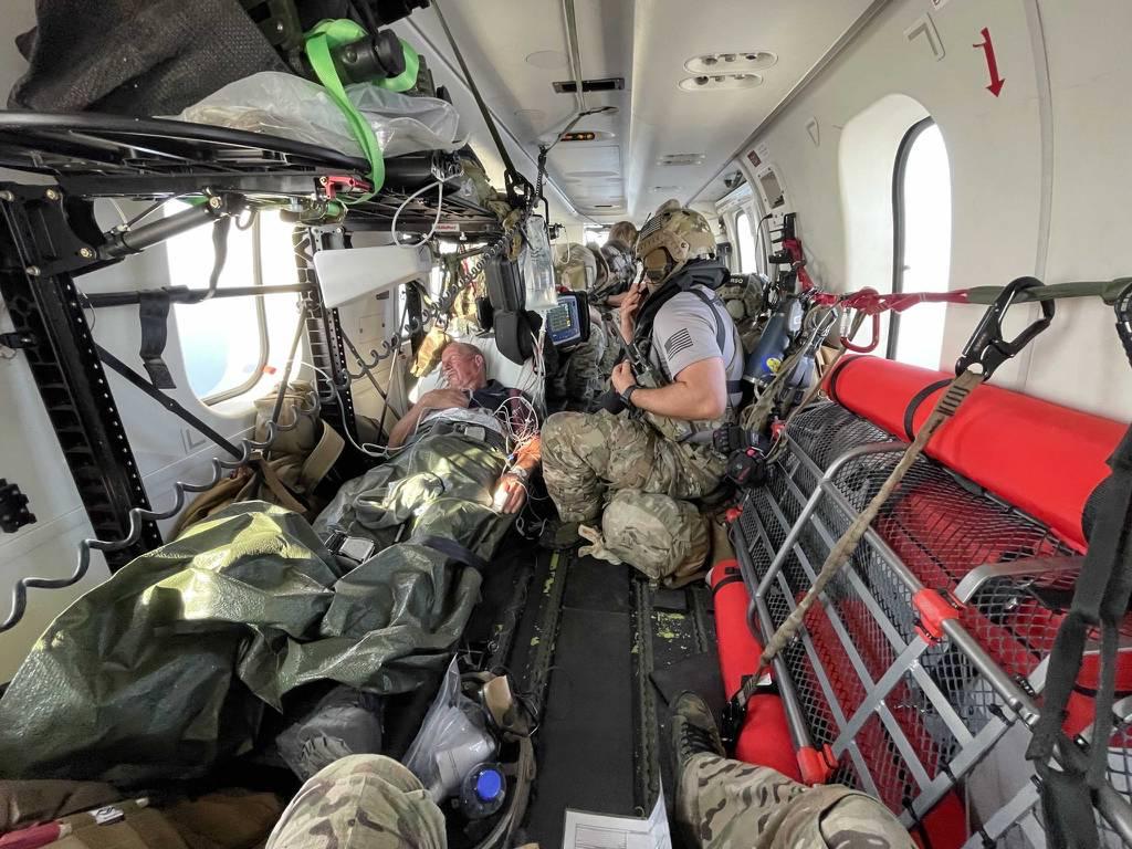 U.S. Air Force PJs treat U.K. mariner Kevin Nixon on board a DHC-8 airplane during a complex two-day medical evacuation from the Indian Ocean, Nov. 13-14, 2021. (AFRICOM) PJs rappel from Osprey to rescue UK mariner off Kenya’s coast