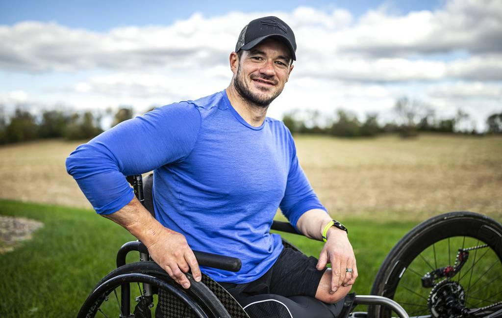 Zach Stinson, posing for a photo, Nov. 3, 2021, is a paratriathlete who competes internationally. Stinson was wounded by an IED in Afghanistan while serving in the Marines. (Dan Gleiter/The Patriot-News via AP) Marine vet who lost legs has new life via God, triathlons, hunting