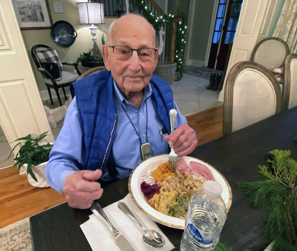 In this photo provided by Holly McDonald, World War II veteran Major Wooten enjoys his Thanksgiving dinner with family in Madison, Ala., on Thursday, Nov. 25, 2021. (Holly McDonald via AP) WWII vet who survived COVID-19 honored on 105th birthday