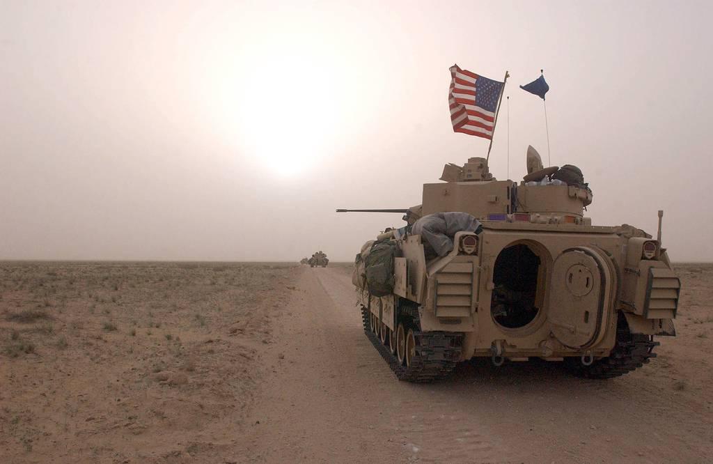 U.S. Army Bradley fighting vehicles take up a position along a road inside the demilitarized zone between Kuwait and Iraq on March 19, 2003. (Scott Nelson/Getty Images)