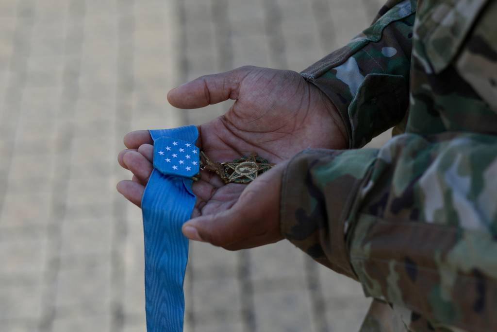 A soldier holds the Medal of Honor. (Army/Spc. Stephen Malone)