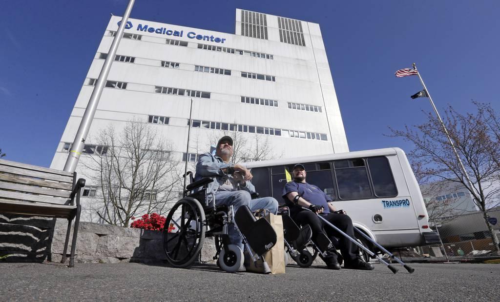 Thumbnail: Veterans wait outside the Puget Sound Veterans Affairs Medical Center in Seattle March 30, 2015. (Elaine Thompson/AP)