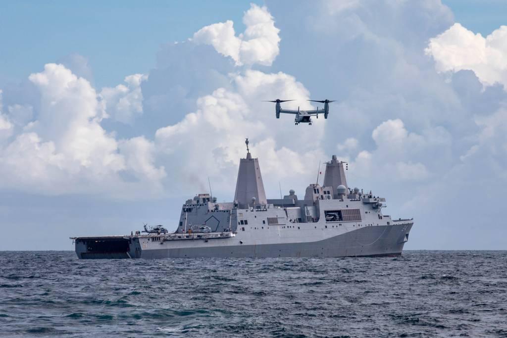 An MV-22 Osprey transport aircraft assigned to Marine Medium Tiltrotor Squadron 266 prepares to land on the amphibious transport dock ship Arlington to deliver supplies in support of the shipâ€™s mission to Haiti, Aug. 18, Sailors, Marines to receive Humanitarian Service Medals for Haiti earthquake relief effort
