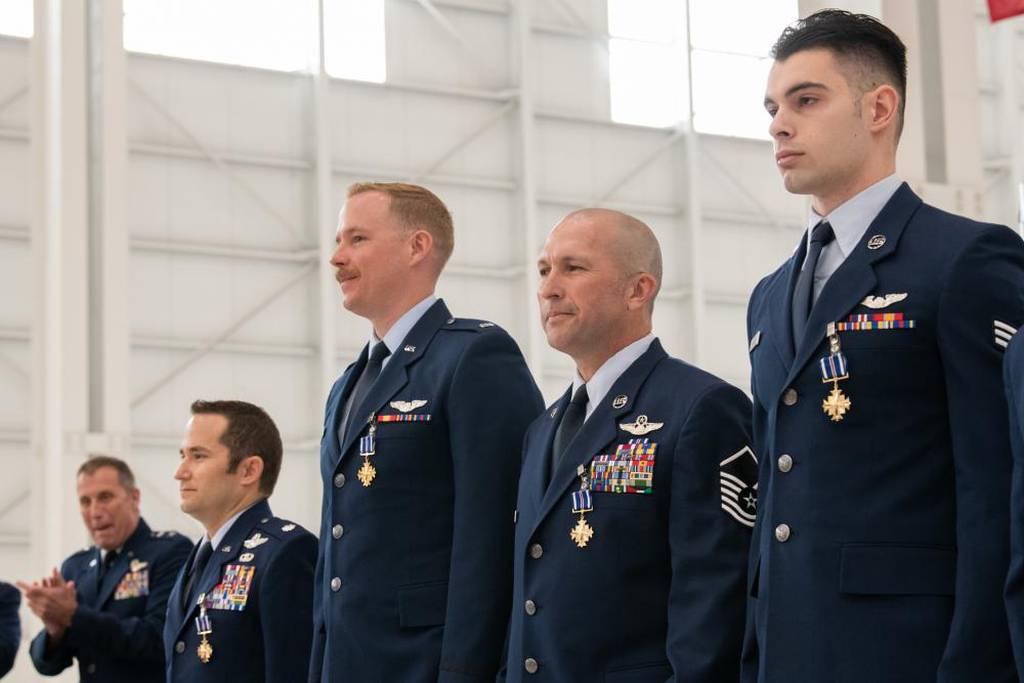 Air Force Reserve Command deputy commander Maj. Gen. Matthew J. Burger, the former boss of the 349th Air Mobility Wing, awards the Distinguished Flying Cross to four C-17A Globemaster III aircrew members during a ceremony  Airmen awarded Distinguished Flying Cross for orchestrating first evacuation from Kabul airport