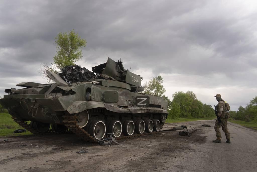 Ukrainian serviceman walks past a blown Russian APC near Kutuzivka, north of Kharkiv, east Ukraine, Sunday, May 15, 2022. (AP Photo/Mstyslav Chernov) Small wins buoy Ukraine; West says Russians losing momentum