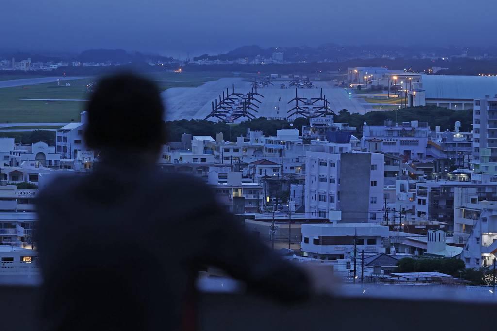 An elderly man visits a height near the U.S. Marine Air Station Futenma in Ginowan, Okinawa, Japan Sunday, May 15, 2022. (Kyodo News via AP) Okinawa marks 50 years of end to US rule amid protests