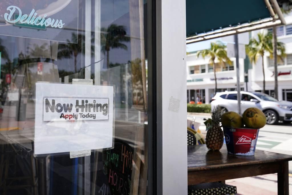 A "Now Hiring" sign is shown in the window of a restaurant in Miami Beach, Fla., on Jan. 7, 2021. (Wilfredo Lee/AP)