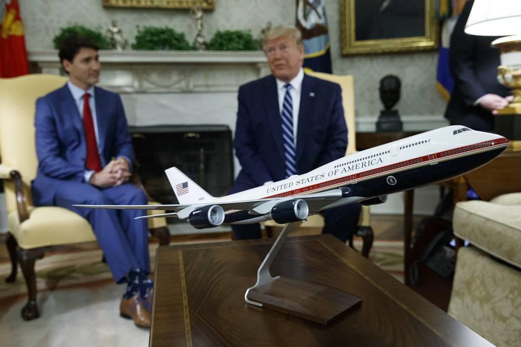 Then-President Donald Trump, right, is seen in the Oval Office of the White House with a mockup of an Air Force One plane. (Evan Vucci/AP) Biden nixes Trump design for Air Force One over cost, delay