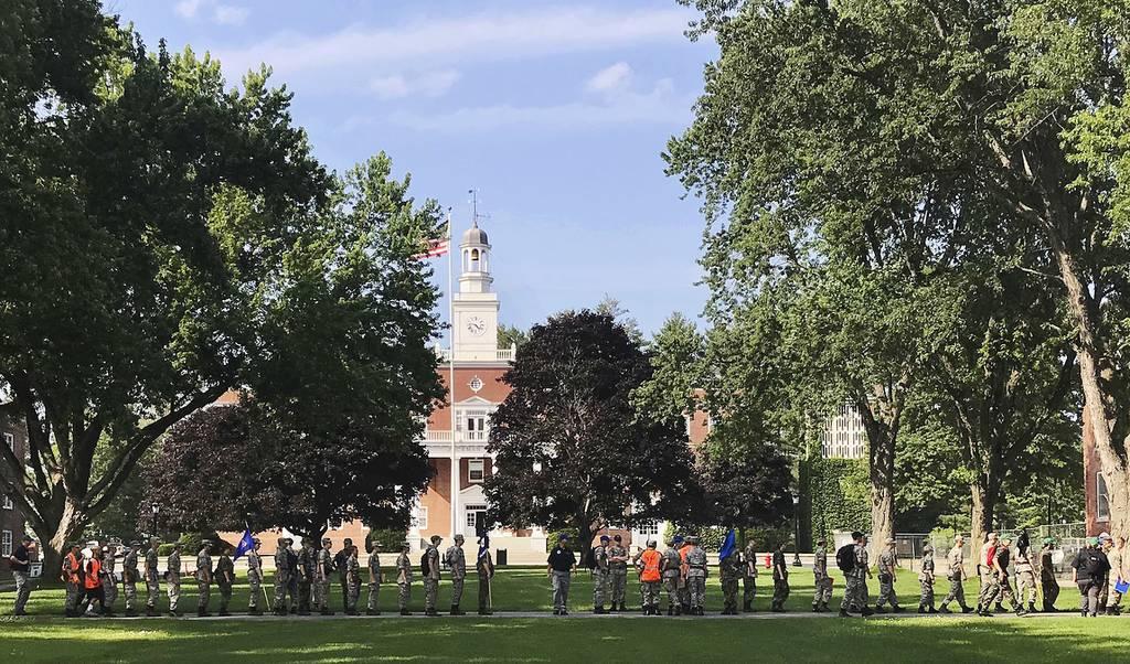 A group in military fatigues walks in front of Jackman Hall on the campus of Norwich University in Northfield, Vt., July 16, 2018. (David Jordan/AP) GI Bill fix would ease financial reporting rules for colleges