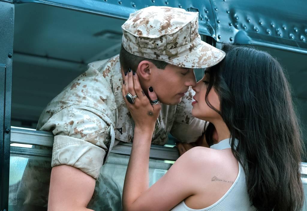 Purple Hearts stars Nicholas Galitzine as Luke and Sofia Carson as Cassie. (Mark Fellman/Netflix)