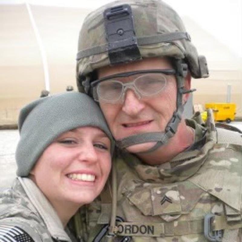 Enlarge Staff Sgt. Clark Jordon, then a corporal, poses with his daughter in Kuwait while on hi... 