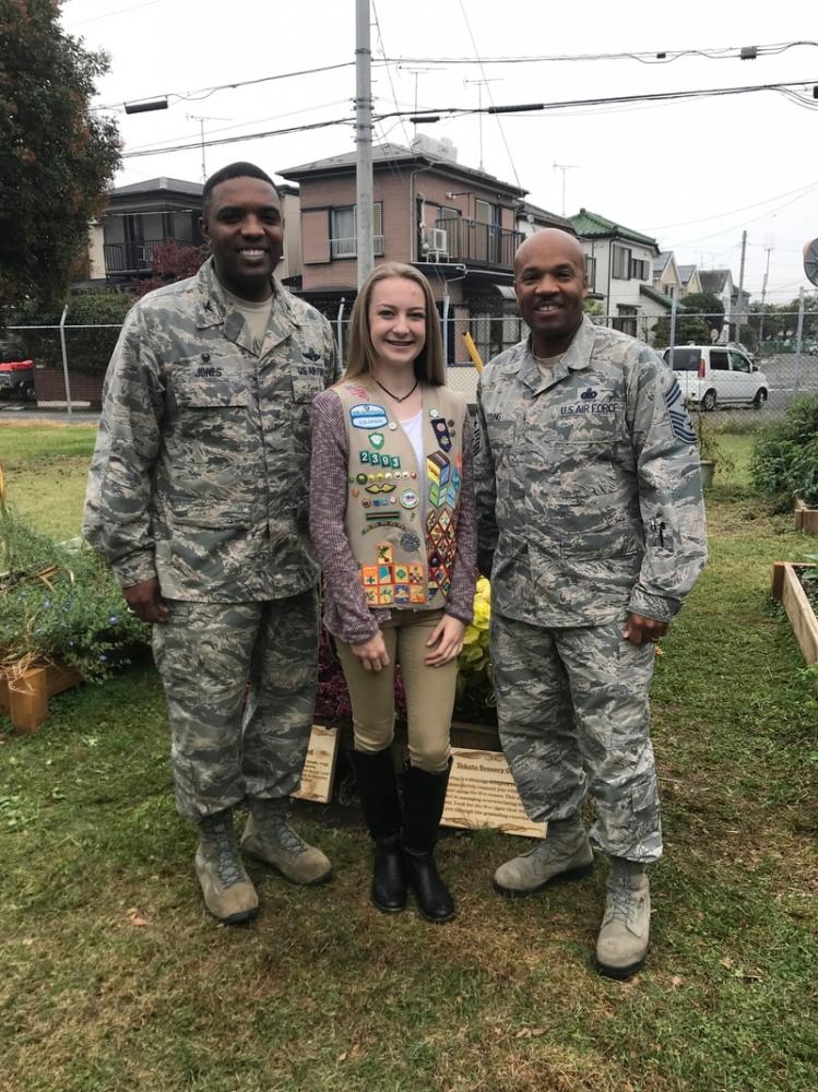 Enlarge Emma in 2018 with Air Force Col. Otis Jones, then base commander, and Chief Master Sgt.... 